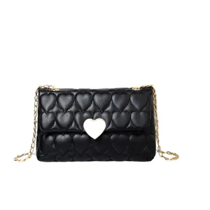 Black heart-quilted shoulder bag featuring a gold heart lock and elegant chain strap