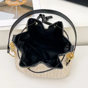 Sac seau minimaliste en paille avec cordon de serrage et finitions en cuir noir