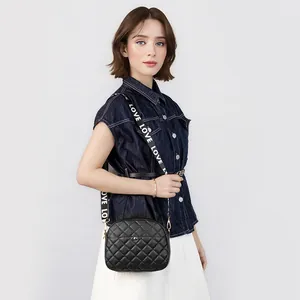 Black quilted crossbody camera bag with wide LOVE embroidered strap and shell shape