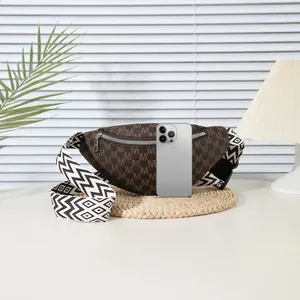 Brown monogram fanny pack with wave pattern strap and phone for scale reference