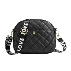 Black quilted crossbody bag with stylish wide canvas strap featuring LOVE lettering