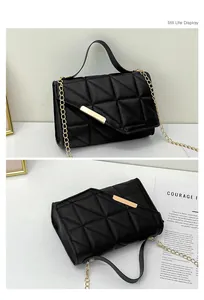 Detail of black quilted leather shoulder bag with gold metal buckle and chain strap