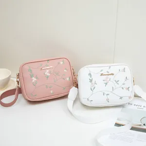 Floral embroidery crossbody bag with wide strap and gold hardware in pink and white