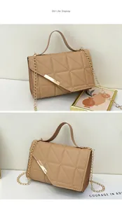Detail of khaki crossbody bag with triangle quilting and gold rectangular metal buckle