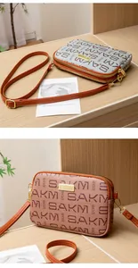 Close-up of dual-layer zipper structure and letter-print patterns on small crossbody bags