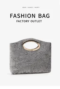 Detailed view of grey textured fabric handbag with elegant oval gold metal handle