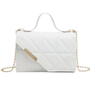 White quilted crossbody bag with golden chain strap and triangular flap detail