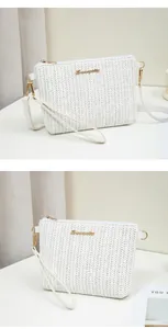 Detail of white woven crossbody bag with golden logo and detachable shoulder strap