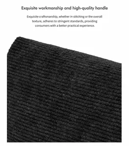 Close-up of black corduroy fabric texture with detailed vertical ribbed patterns