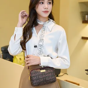 Deep brown leather crossbody bag with letter print and golden hardware on model