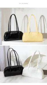 Drei minimalistische Baguette-Taschen aus glänzendem Kunstleder in Schwarz, Gelb und Weiß