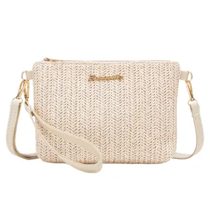 Woven striped crossbody bag in cream straw with gold hardware and removable straps