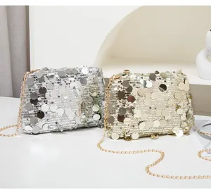 Detail view of shimmering gold and silver sequin crossbody bags with chain straps