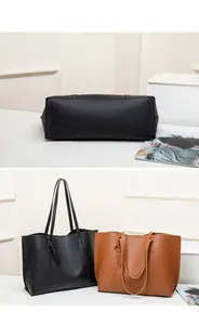 Detail view of large tote bags in black and brown featuring lychee grain leather texture