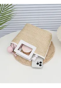Top-down view of woven straw tote bag showing internal storage for daily essentials