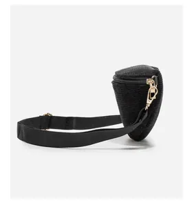 Side view of black corduroy crossbody bag with golden metal buckle and zipper detail
