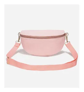 Detail of pink corduroy fanny pack with golden metal buckle and adjustable nylon strap