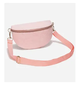 Detail of pink corduroy crossbody bag texture with premium metal buckles and zipper