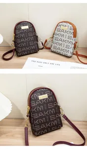 Detail of dual zipper mini crossbody bags with SAKM letter print and metal logo plates