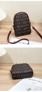 Macro detail showing vintage monogram pattern and high-quality gold hardware on crossbody bag