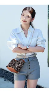 Outdoor lifestyle shot of a women's sequin bucket bag with a stylish casual outfit