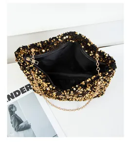 Detailed top view of golden sequin shoulder bag with chain strap and black lining
