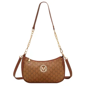 Fashionable dark brown crescent moon bag with M-letter monogram and gold logo buckle
