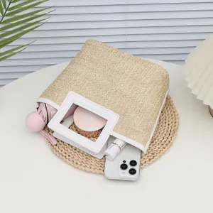 Chic beige woven straw handbag with white leather handles and summer travel essentials