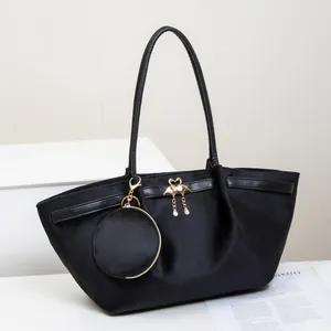 Large black suede tote bag for women with golden flamingo pendant and round coin purse