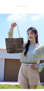 Outdoor lifestyle shot of a champagne sequin tote bag with a golden chain strap