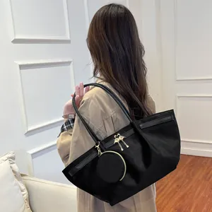 Black large suede tote bag with golden bird pendant and mini round coin purse