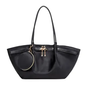 Black suede tote bag with golden flamingo heart clasp and matching round coin pouch