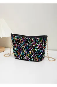 Detail of colorful sequins on a stylish crossbody bucket bag with gold chain strap