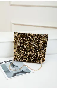 Close-up of black and gold sequins on the chain bag with metallic texture