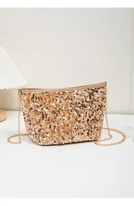 Detail of glittery gold sequins and elegant gold chain on a fashion bucket bag
