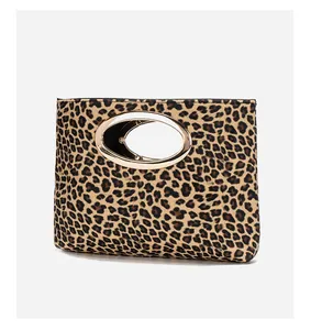 Dettaglio borsa da sera leopardata con manico ovale in metallo dorato su corpo piatto