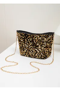 Detail of golden sequins and metallic chain strap on a black luxury evening bucket bag