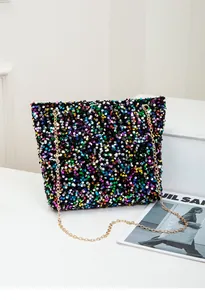 Detailed close-up of vibrant multicolored sequins and gold chain strap on shoulder bag