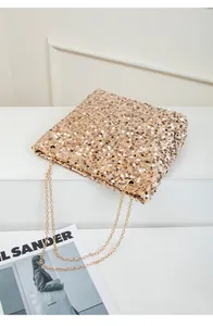 Detail of champagne gold sequin tote bag showing dense texture and gold chain strap