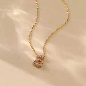 Elegant gold letter E necklace with zircon pavé setting on a delicate chain