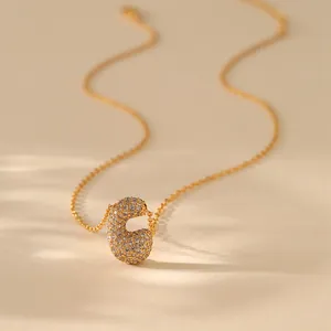 Macro detail of gold-plated bean pendant with shimmering cubic zirconia micro-inlay