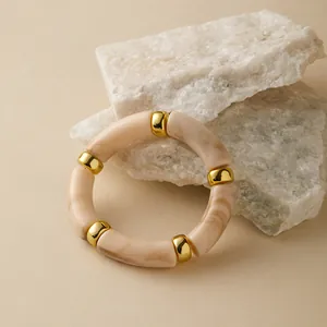 Nahaufnahme des böhmischen Marmor-Harz-Armbands mit polierten Gold-Metall-Zwischenteilen