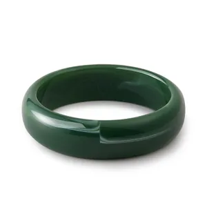 Detail of dark green acrylic wide bangle showing marble texture and polished finish