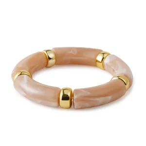 Bohemian elastic bracelet featuring light amber marbled resin beads and gold metal spacers