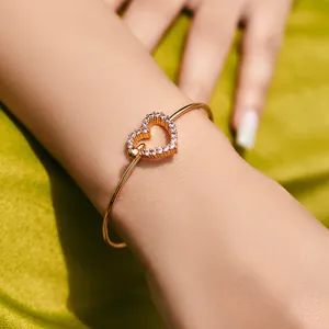 Detail of 18K gold-plated brass cuff bracelet featuring a lavender heart zircon pendant