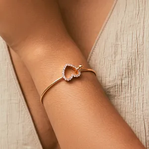 Detailed close-up of a 18K gold plated heart bracelet with shimmering zircon stones