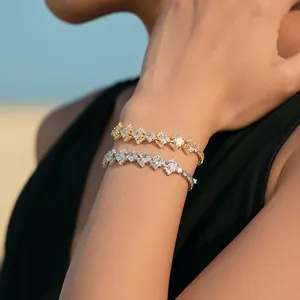 Detail of 18K gold and silver plated bracelets with square and baguette cubic zirconia