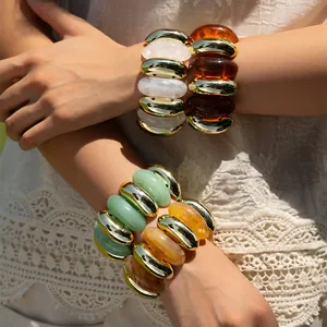 Bohemian elastic beaded bracelet set with amber and resin oval beads in gold finish