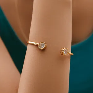 Macro detail of 18K gold-plated cuff bracelet featuring two sparkling zircon stones