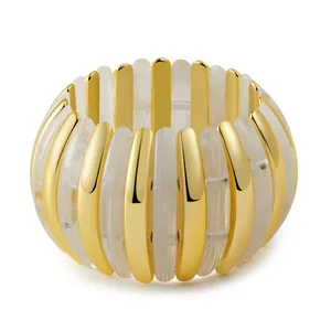 Close-up of bohemian acrylic marble resin and golden metal stretch bracelet details